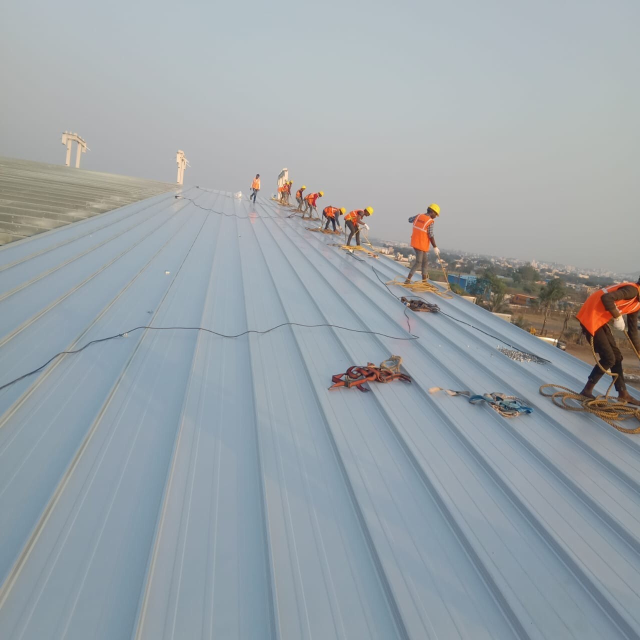 Architectural standing seam roofing for Lodha Mumbai: Premium metal building envelope featuring a minimalist aesthetic and hidden fastener technology by Rishonn & Reyansh.